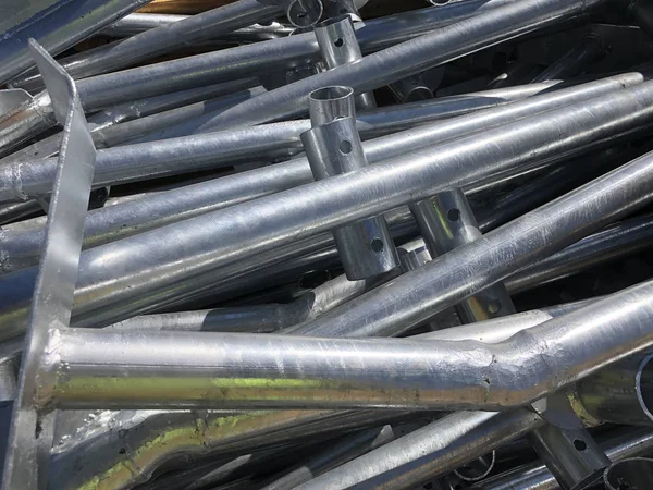 Chrome plated formwork supporting metal pipes in the box on the outdoor warehouse — Stock Photo, Image