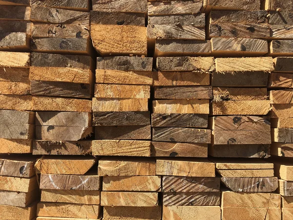 Stack of lumber at the outdoor warehouse. Stockpiled edged boards — Stock Photo, Image