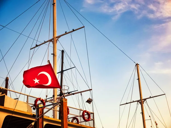 Turkish flag is waving on the top of nautical vessel