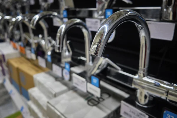 Row of brand new chrome colored water faucets — Stock Photo, Image