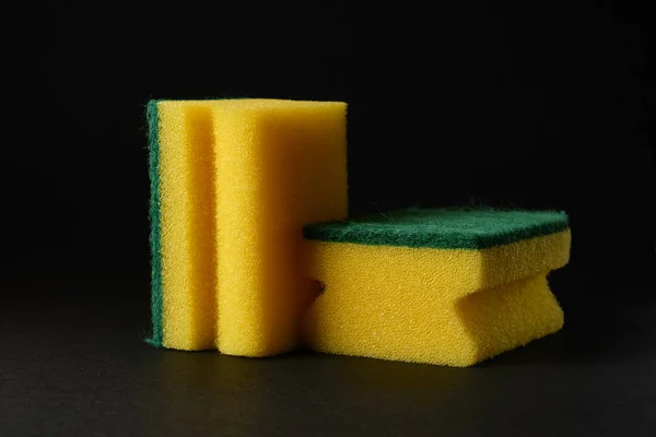 Two new yellow sponges against black background — Stock Photo, Image