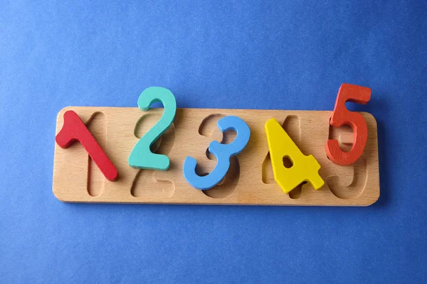 Multi colored toy numbers at blue background with copy space Stock Image