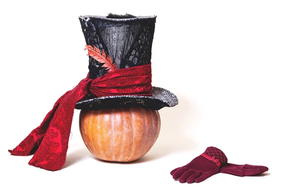 Large cylindrical hat on orange pumpkin. Near gloves — Stock Photo, Image