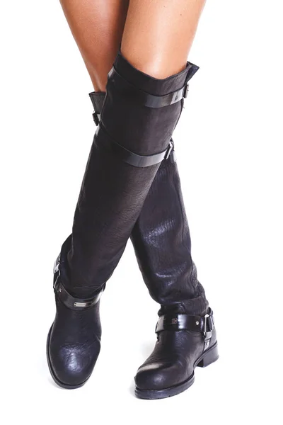 Crossed shapely female legs in high leather boots — Stock Photo, Image