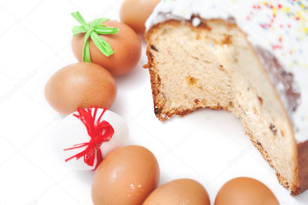 Cut cake and number of Easter eggs on white background