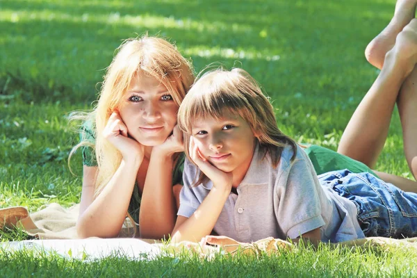 Семейная идиллия. Мать и сын на зеленой лужайке — стоковое фото