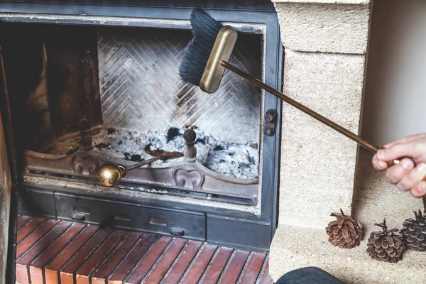 Man cleans fireplace with brush and blades — Stock Photo, Image