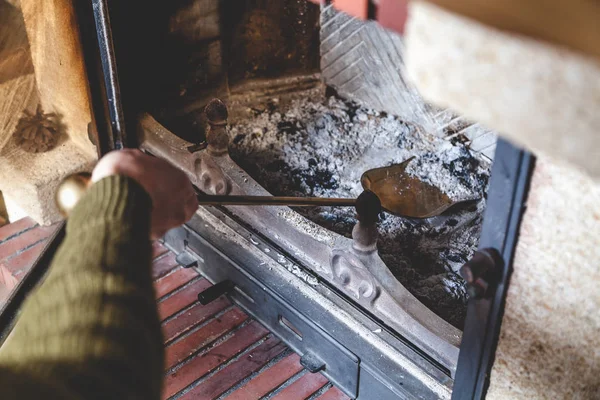 Cleaning  fireplace. Hand holding  shovel with ash — Stock Photo, Image