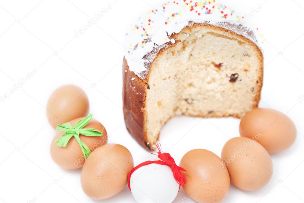 Cut cake and number of Easter eggs on white background