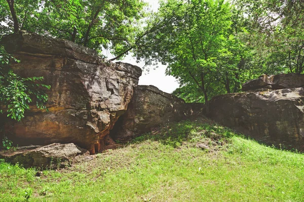 Large boulder in shade of trees — Stock Photo, Image