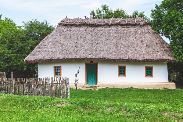 Picturesque old hut with three windows in Ukrainian styl