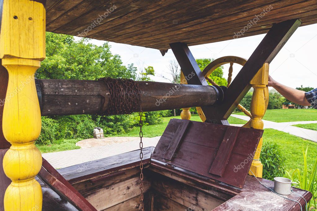 Wooden carved well with open hatch