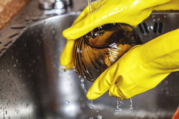 Sarı lastik eldiven elinde kaşık cam kase yıkamak — Stok fotoğraf