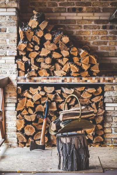 Подрібнені дрова укладаються на ганок. Наступна сокира пенька стек деревини — стокове фото