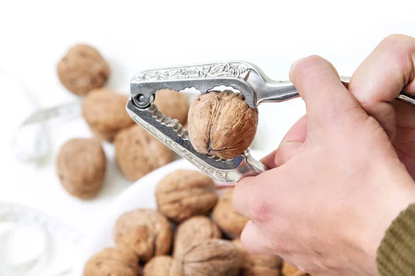 Large walnut in tongs for nuts — Stock Photo, Image