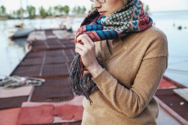 Kız iskelede duran ve eşarp bağlama