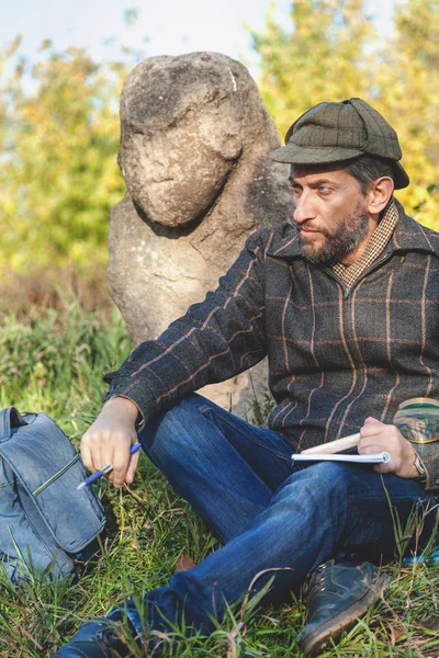 öğrenilen tarihçi önce taş heykel Höyük üzerinde oturur.