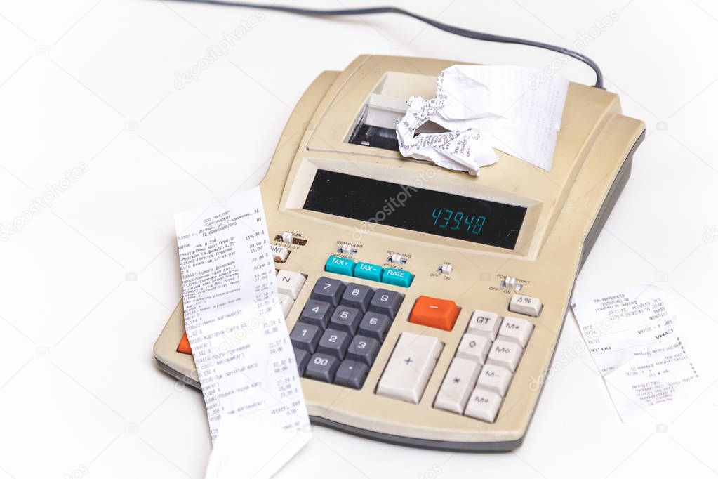 Paper checks lie near cash register