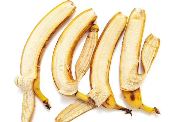 Cztery częściowo obrane banany kłamstwie w poziomym rzędzie — Zdjęcie stockowe