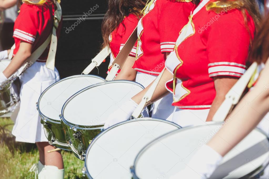 Group drummer girls in uniform on summer holiday