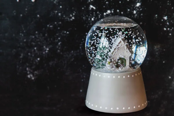 Glass ball with snowflake on dark background