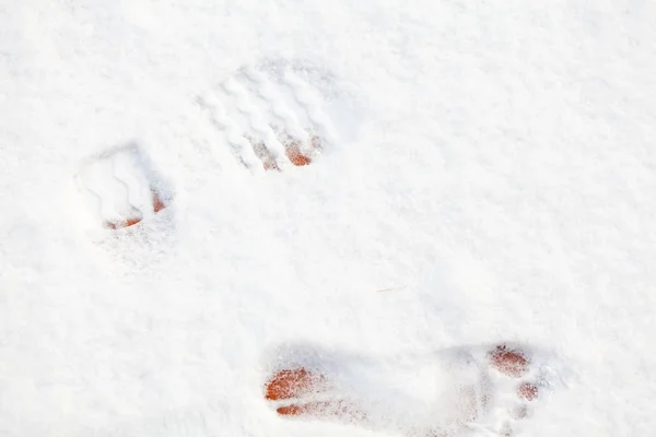 Footprint of  barefooted foot on white snow