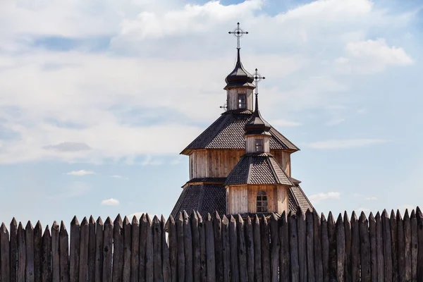 Wooden stockade and church bathed