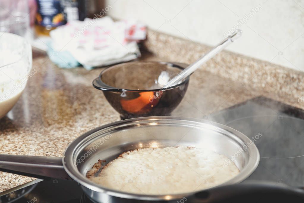 White pancake fry on white frying pan