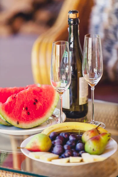 Meyve ve şarap. -Bir şişe şampanya, karpuz ve meyve — Stok fotoğraf