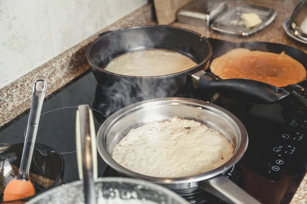 Pfannkuchen in mehreren Pfannen kochen — Stockfoto