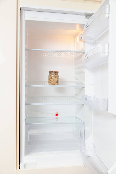 Bank of canned mushrooms on  shelf of  refrigerator