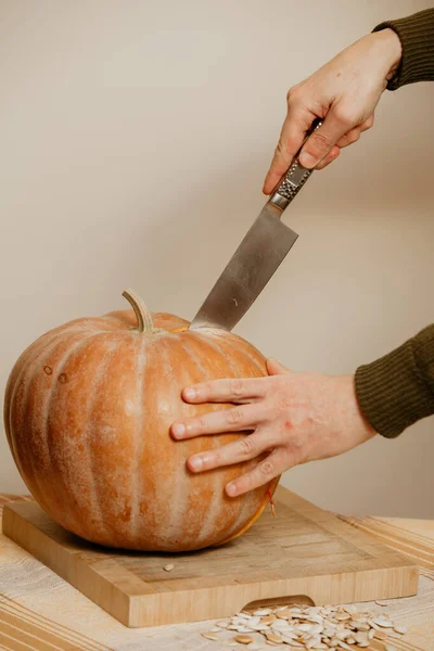 Uomo mani tagliate zucca matura con grande coltello — Foto Stock