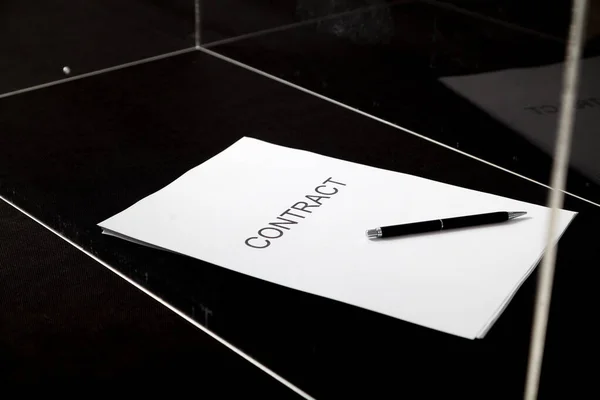 Contract and pen lie in transparent box — Stock Photo, Image