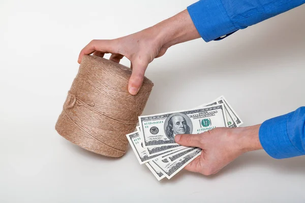 Hands holding dollars and roll of bank rope close-up — 스톡 사진