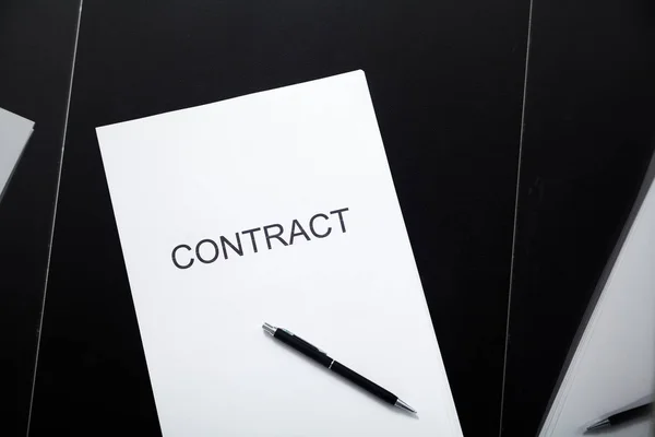Transparent contract. A contract printed on paper and a pen lies in a glass box close-u