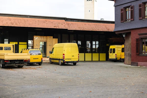 Distribution warehouse factory with vans and rucks in a row — ストック写真