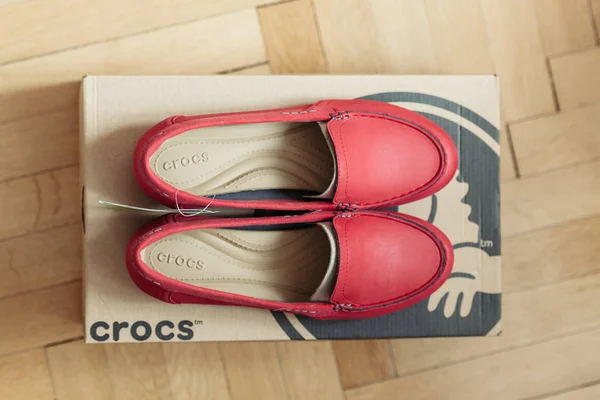 Crocs shoes on wooden parquet floor — Stock Photo, Image