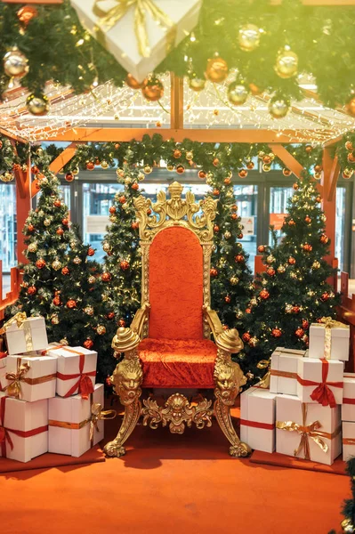 Santa\'s office red gold throne with white gifts with red ribbon