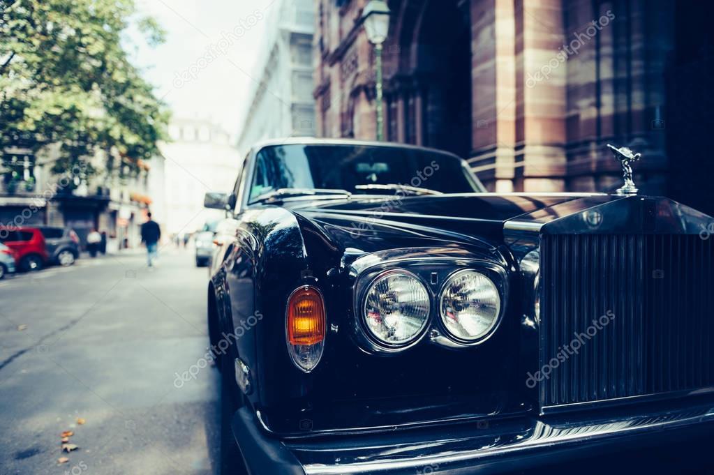 PARIS, FRANCE - SEP 12, 2016: Front view of Exclusive Luxury Rolls-Royce car limousine parked in city during fashion wedding vip event waiting for passenger. Rolls-Royce Limited is a British car-manufacturing and, later, aero-engine manufacturing com