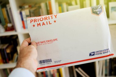 USPS United States Postal Service Parcel envelope in man's hands clipart