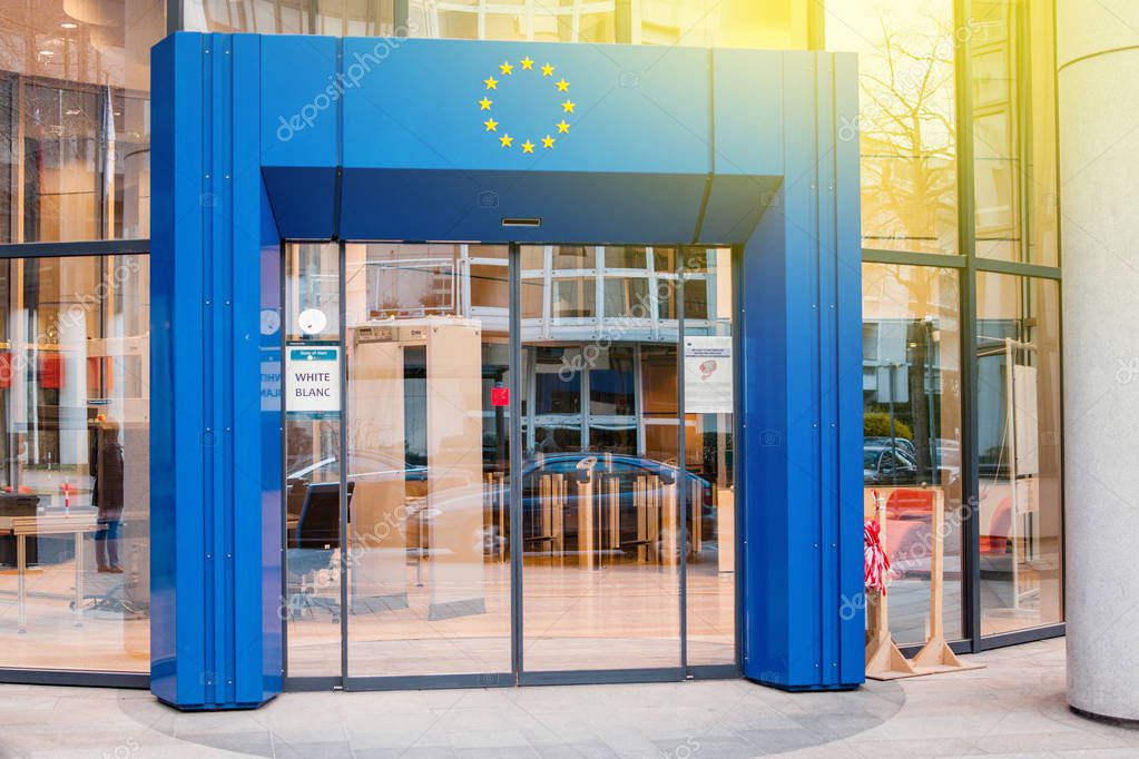 STRASBOURG, FRANCE - MARCH 24, 2015: Official delegation entrance to Council of Europe European Union with blue gate and European Union Stars logo above and white security code badge on the door.