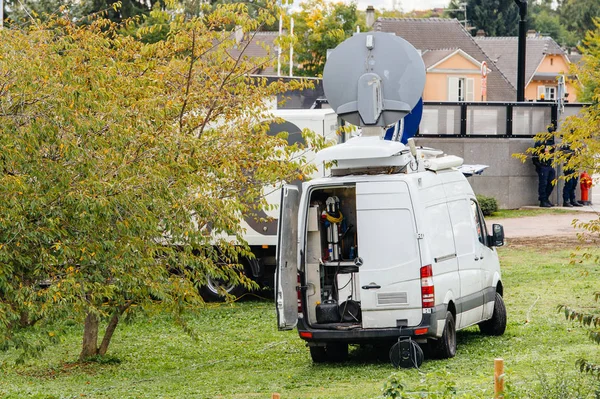 Rear view of white Tv Television Trucks with multiple Satellite