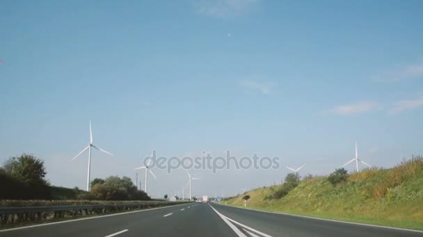 Wind turbines by fast highway — Stock Video