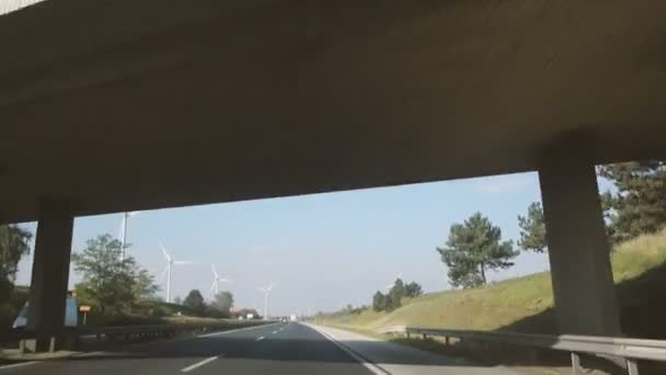 Wind turbines by fast highway — Stock Video