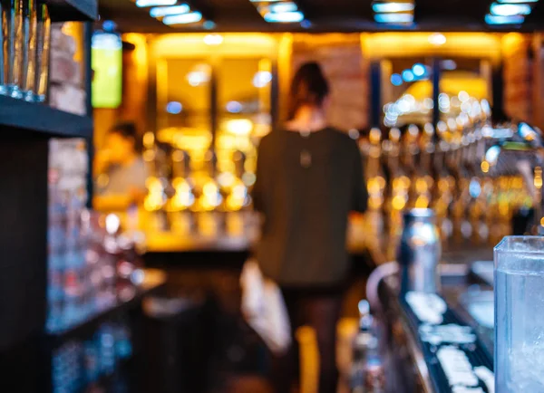 Uitzicht op het silhouet van bar meid barman vrouw in bier aan de achterkant wi — Stockfoto