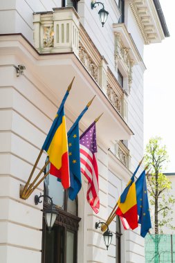 European Union United States and Romanian flags on a building fa clipart