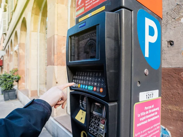 Woman paying for parking at the new Parking ticket payment machi