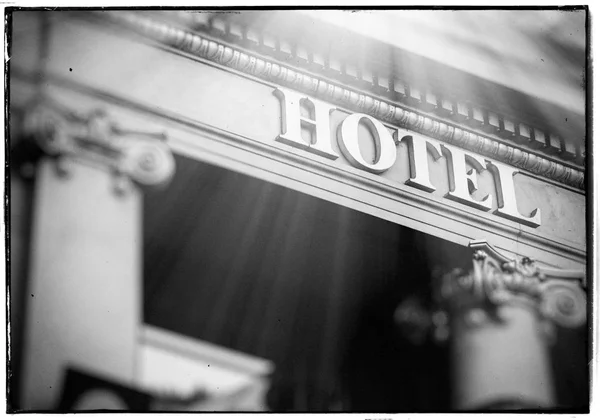 Black and white hotel entrance sign letters sun beam — Stock Photo, Image