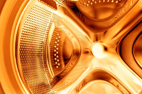 Inside the washing machine - golden cleaning — Stock Photo, Image
