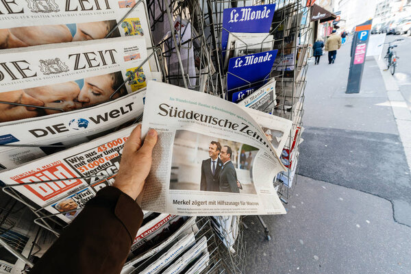 Man buying Suddeutsche Zeitung with the newly elected French pre